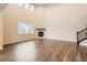 Bright living room featuring a fireplace, hardwood floors, and large windows at 9771 Rosalee Peak St, Littleton, CO 80125