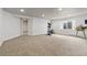 Spacious carpeted basement featuring neutral tones, a window, and open access to other parts of the home at 2333 Paint Pony Cir, Castle Rock, CO 80108
