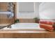 Modern bathroom features a soaking tub with tile surround and decorative plants, creating a spa-like experience at 2333 Paint Pony Cir, Castle Rock, CO 80108