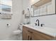 Modern bathroom boasts a sleek vanity with a white countertop, a black faucet, and a large mirror at 2333 Paint Pony Cir, Castle Rock, CO 80108