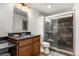 Modern bathroom with a glass shower, granite countertop vanity, and stylish tile accents at 2333 Paint Pony Cir, Castle Rock, CO 80108