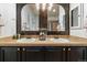 Bathroom vanity with double sinks and wood framed mirrors at 2333 Paint Pony Cir, Castle Rock, CO 80108