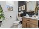 Stylish half-bathroom showcasing a modern vanity, decorative wall art, and a view of the outdoors through the window at 2333 Paint Pony Cir, Castle Rock, CO 80108
