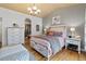 Cozy bedroom with neutral color scheme, hardwood floors, and ensuite bathroom at 2333 Paint Pony Cir, Castle Rock, CO 80108