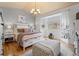 Bright bedroom with ensuite bathroom, plush bedding, hardwood floors and plenty of natural light at 2333 Paint Pony Cir, Castle Rock, CO 80108