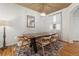 Bright dining room with wood floors, modern lighting, and comfortable seating at 2333 Paint Pony Cir, Castle Rock, CO 80108