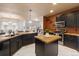 Wide shot of kitchen with center island, butcher block countertops, stainless steel appliances, and a view to the living room at 2333 Paint Pony Cir, Castle Rock, CO 80108