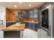 Modern kitchen with stainless steel refrigerator and microwave, and a center butcher block island at 2333 Paint Pony Cir, Castle Rock, CO 80108