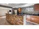 Basement kitchenette with black countertops, stainless steel appliances, and a brick bar for a cozy entertaining space at 2333 Paint Pony Cir, Castle Rock, CO 80108