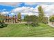 Community playground with green grass, blue skies and tall trees at 2333 Paint Pony Cir, Castle Rock, CO 80108