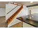 Elegant staircase with wooden steps and railings, adjacent to a bar area, creating a warm and inviting atmosphere at 2333 Paint Pony Cir, Castle Rock, CO 80108