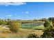 Outdoor tennis court surrounded by mature trees and a walking path with clear blue skies at 2333 Paint Pony Cir, Castle Rock, CO 80108