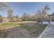 Expansive backyard featuring grass, a privacy fence, mature trees, and a storage shed at 3094 S Hobart Way, Denver, CO 80227