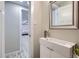 Hall bathroom with a modern vanity and mirror with open views to another bedroom at 3094 S Hobart Way, Denver, CO 80227