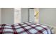 Bedroom with wood-look floors and open doors to ensuite bathroom and hallway at 3094 S Hobart Way, Denver, CO 80227