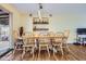 Spacious dining area with a large table, chairs, and a sliding glass door at 3094 S Hobart Way, Denver, CO 80227