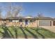 Charming ranch-style home with brick facade, manicured lawn, and a blue front door at 3094 S Hobart Way, Denver, CO 80227