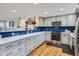 Modern kitchen featuring stainless steel appliances, quartz countertops, and blue backsplash at 3094 S Hobart Way, Denver, CO 80227