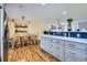 Open-concept kitchen flows seamlessly into dining room with stylish gray cabinets and quartz counters at 3094 S Hobart Way, Denver, CO 80227