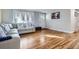 Bright living room with hardwood floors, a modern sofa, and ample natural light at 3094 S Hobart Way, Denver, CO 80227