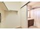 Bathroom with tile countertops, brown cabinets, white shower curtain, and closet space at 13151 Grant N Cir # C, Thornton, CO 80241