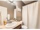 Bathroom featuring a cream countertop, stylish mirror, white shower curtain, and a towel rack at 13151 Grant N Cir # C, Thornton, CO 80241