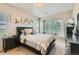 Tranquil bedroom featuring a large window, plush bedding, and a peaceful ambiance at 13151 Grant N Cir # C, Thornton, CO 80241