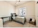 Bedroom with carpet, window, desk, and bed with decorative pillows at 13151 Grant N Cir # C, Thornton, CO 80241