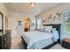 Serene bedroom with neutral tones, decorative artwork, and an ensuite bathroom at 13151 Grant N Cir # C, Thornton, CO 80241