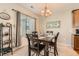 Cozy dining room featuring a chandelier, large window, and stylish decor at 13151 Grant N Cir # C, Thornton, CO 80241