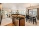 Open-concept living space showcasing the kitchen, dining area, and access to the outdoors at 13151 Grant N Cir # C, Thornton, CO 80241