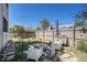 Backyard with fire pit, patio furniture, a garden, privacy fence, and mature landscaping at 1403 Valentia St, Denver, CO 80220