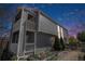 Multi-level home with balconies and small yard with fresh landscaping in a residential neighborhood at 1403 Valentia St, Denver, CO 80220