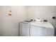Laundry room featuring modern, front-load washer and dryer at 1403 Valentia St, Denver, CO 80220