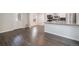 Open-concept living space with wood-look floors, neutral walls, and a kitchen bar area at 1403 Valentia St, Denver, CO 80220