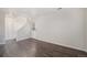 Bright living room with wood-look floors, white walls, and a staircase leading to the upper level at 1403 Valentia St, Denver, CO 80220