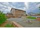 Spacious backyard with fire pit, sport court, and well-maintained lawn, perfect for outdoor activities at 735 Woodmoor Acres Dr, Monument, CO 80132