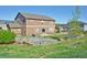 Spacious backyard with a patio, hot tub, fire pit, and well-kept landscaping at 735 Woodmoor Acres Dr, Monument, CO 80132