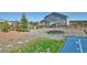 Backyard view featuring trampoline, stone walkway, and partial basketball court with well-kept landscaping at 735 Woodmoor Acres Dr, Monument, CO 80132