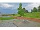 Landscaped backyard with fire pit, basketball court and plenty of space to entertain at 735 Woodmoor Acres Dr, Monument, CO 80132