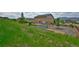 A spacious yard with a basketball court and trampoline with mountain views in the background at 735 Woodmoor Acres Dr, Monument, CO 80132