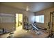 Basement home gym area featuring workout equipment, weights, and exercise chart at 735 Woodmoor Acres Dr, Monument, CO 80132