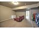 Finished basement area with a comfortable sofa and a neutral color scheme at 735 Woodmoor Acres Dr, Monument, CO 80132