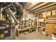Unfinished basement with storage shelving, a furnace, and ample room for future customization at 735 Woodmoor Acres Dr, Monument, CO 80132