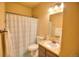 Clean bathroom featuring a shower with curtain, modern vanity and ample lighting at 735 Woodmoor Acres Dr, Monument, CO 80132