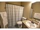 The cozy bathroom is complete with granite counters, a shower-tub combo, and a sink at 735 Woodmoor Acres Dr, Monument, CO 80132