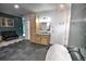 Beautiful primary bathroom featuring a soaking tub, green accent wall, and modern vanity at 735 Woodmoor Acres Dr, Monument, CO 80132