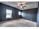 Bedroom featuring neutral carpet, a ceiling fan, and natural light from two windows at 735 Woodmoor Acres Dr, Monument, CO 80132