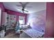 A stylish bedroom with purple hues, a rainbow wall mural, and ample display shelving at 735 Woodmoor Acres Dr, Monument, CO 80132