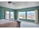Bright bedroom with large windows offering scenic views, complemented by neutral carpet and soothing wall color at 735 Woodmoor Acres Dr, Monument, CO 80132